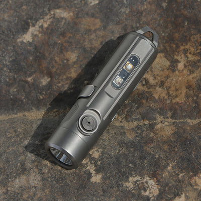 Silver flashlight on a textured stone surface