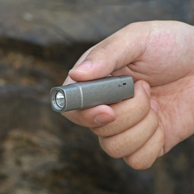 FIELDLUME T7 tail switch titanium flashlight detail for quick activation